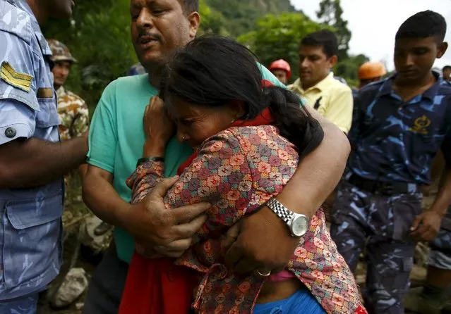 A family member cries after a dead body is recovered from the landslide at Lumle village in Kaski district July 30, 2015. (Photo by Navesh Chitrakar/Reuters)
