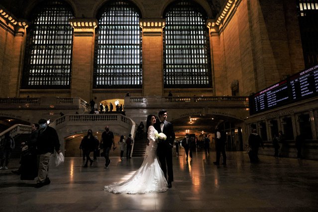 A couple poses for wedding photographs inside Grand Central Station in New York City, New York, U.S., May 5, 2022. (Photo by Shannon Stapleton/Reuters)