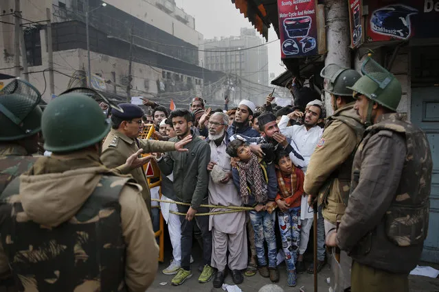 Indian policemen stop protesters at a police barricade in New Delhi, India, Friday, December 20, 2019. (Photo by Altaf Qadri/AP Photo)