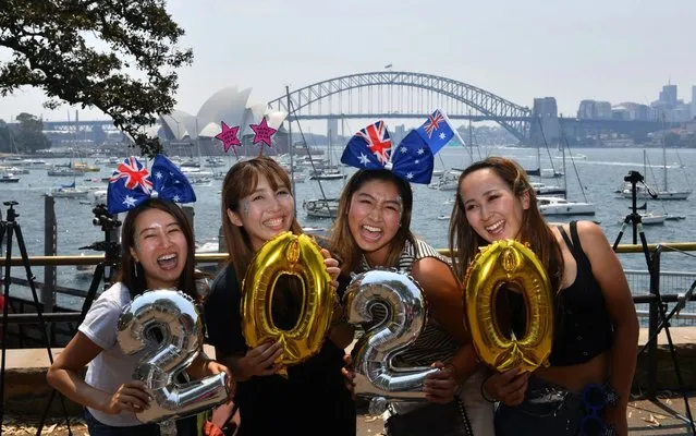 New Year's Eve revellers from Asia with Australian flags and balloons in the shape of the new year 2020 in Sydney, Australia on December 31, 2019. (Photo by Richard Milnes/Rex Features/Shutterstock)
