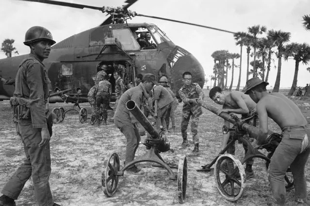 South Vietnamese soldiers prepare to load Chinese-made recoilless rifles aboard a waiting helicopter in Cambodia, 85 miles northeast of Phnom Penh, on May 25, 1970. The weapons were captured as the troops advanced down route seven toward the Chup rubber plantation. (Photo by Nick Ut/AP Photo)