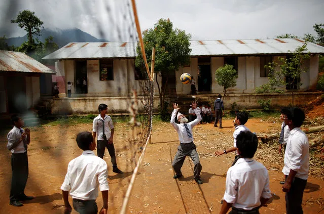 Durga Kami, 68, who is studying in the tenth grade at Shree Kala Bhairab Higher Secondary School, plays volleyball with friends during a break in Syangja, Nepal, June 5, 2016. (Photo by Navesh Chitrakar/Reuters)