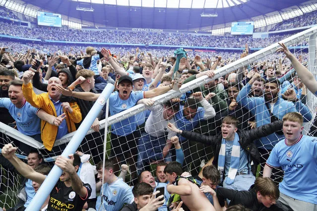 Manchester City fans invade the pitch after their side won the English Premier League following a 3-2 victory over Aston Villa at The Etihad Stadium, Manchester, England, Sunday, May 22, 2022. (Photo by Martin Rickett/PA Wire via AP Photo)