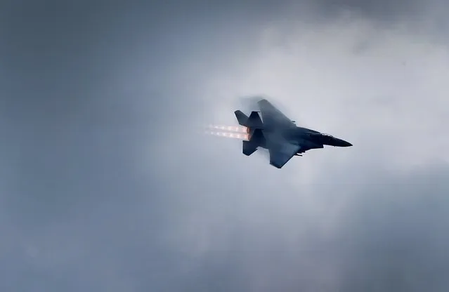 A Singapore Airforce F-15SG fighter aircraft executes a combat turn as part of celebrations for Singapore's 50th year of independence, Sunday, August 9, 2015, in Singapore. (Photo by Wong Maye-E/AP Photo)