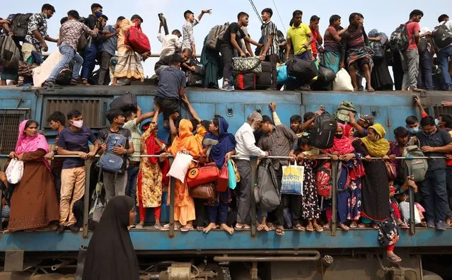 Risky train journey for Eid al fitr 2022 in Joydebpur, Gazipur on April 30, 2022. Eid-ul-Fitr is one of the biggest festivals of Muslims. Everyone wants to celebrate this festival with their family members. At this time people try to go to their city anyway. They take any kind of risk to get home. Thousands of people are traveling in the overflowing train. People travel on the roof of the train as there are no seats available inside. About half of the city dwellers left the city this time. (Photo by Syed Mahabubul Kader/ZUMA Press Wire/Rex Features/Shutterstock)