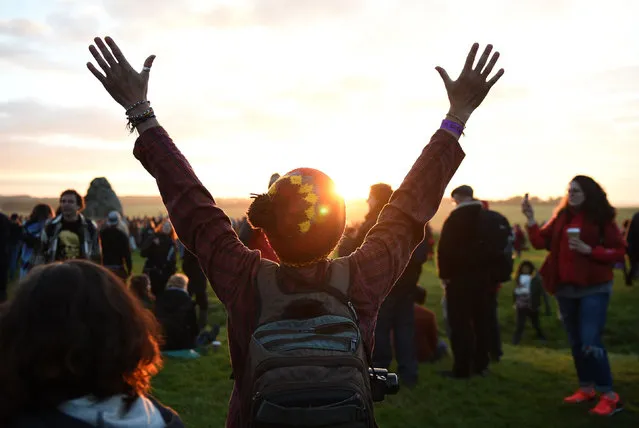 Excitement as the sun begins to rise during the summer solstice at the Stonehenge in Wiltshire, Britain, on June 21, 2016. (Photo by Andrew Matthews/PA Wire)