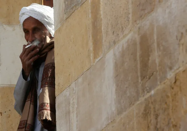 An elderly man smokes his cigarette in front of his house at Manshiet Nasser shanty town in the capital Cairo, Egypt February 13, 2017. (Photo by Amr Abdallah Dalsh/Reuters)