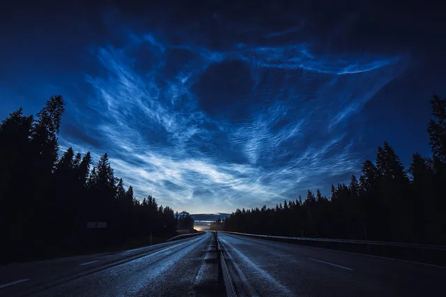“The Road Back Home”, Ruslan Merzlyakov (Latvia). Noctilucent clouds stretch across the Swedish sky illuminating a motorcyclist’s ride home in this dramatic display. Noctilucent clouds are the highest clouds in the Earth’s atmosphere and form above 200,000 ft. Thought to be formed of ice crystals, the clouds occasionally become visible at twilight when the sun is below the horizon and illuminates them. (Photo by Ruslan Merzlyakov/National Maritime Museum/The Guardian)
