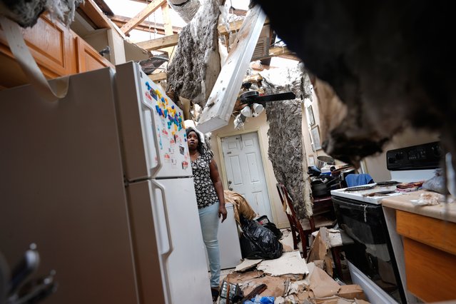 Natasha Ducre surveys the kitchen of her devastated home, which lost most of its roof during the passage of Hurricane Milton, in Palmetto, Fla., Thursday, October 10, 2024. Ducre, her husband, three children and two grandkids, rode out the storm in a government shelter and returned to find their home unlivable and much of their furniture and belongings destroyed by rainwater. (Photo by Rebecca Blackwell/AP Photo)