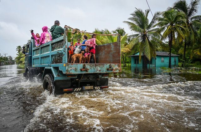 Residents of Guanimar move on a truck to safe zones after the passage of Hurricane Helene in Guanimar, Artemisa province, Cuba, on September 25, 2024. Tropical Storm Helene became a hurricane mid-morning in the Gulf of Mexico. "Life-threatening storm surge, hurricane-force winds, rainfall and flooding are expected across much of Florida and the southeastern United States," the Miami-based National Hurricane Center (NHC) said in its latest bulletin. (Photo by Yamil Lage/AFP Photo)