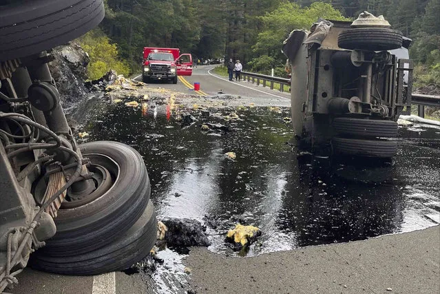 This Tuesday, April 29, 2022 photo released by the U.S. Forest Service – Six Rivers National Forest shows a semi-truck that had a damaged tire as it traveled on State Route 199 in Del Norte County near Gasquet, Calif. The truck crashed on a remote highway spilled 2,000 gallons of hot asphalt binder in a Northern California forest near Gasquet, Calif. The driver was arrested on suspicion of DUI. The trailer eventually overturned, spilling hot asphalt binder, which began seeping into the Smith River. Del Norte County Office of Emergency Services says there is no impact to water quality. (Photo by U.S. Forest Service via AP Photo)