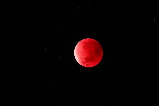 Supermoon Eclipse Boras, Sweden. On September 28, 2015, a supermoon coincided with a lunar eclipse, resulting in this photograph of the moon in a striking shade of red. A lunar eclipse occurs when the moon passes directly behind the Earth and is cloaked by our planet’s shadow. The only visible light is refracted through it, creating the unusual colour. Due to its red hue, a lunar eclipse is often referred to as a “blood moon”. (Photo by Peter Folkesson/National Maritime Museum)