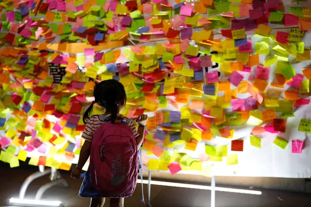 A child looks at messages in support of student leaders Joshua Wong, Nathan Law and Alex Chow who were imprisoned for their participation of the 2014 pro-democracy Umbrella Movement, also known as “Occupy Central” protests on a wall, during a protest in Hong Kong, China August 20, 2017. (Photo by Tyrone Siu/Reuters)