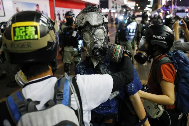 A journalist is covered in pepper spray as riot police disperse anti-government protesters after a clash, at Mong Kok, in Hong Kong, February 29, 2020. (Photo by Tyrone Siu/Reuters)