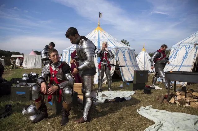 Historical re-enactors in a living history camp prepare their costumes as they take part in an anniversary event for the Battle of Bosworth near Market Bosworth in central Britain August 22, 2015. (Photo by Neil Hall/Reuters)