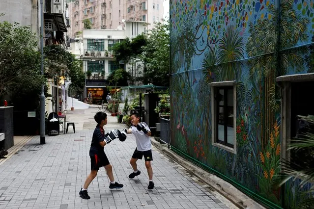 Children practise boxing on a street, ahead of the 25th anniversary of Hong Kong's handover to China from Britain, in Hong Kong, China on May 23, 2022. (Photo by Tyrone Siu/Reuters)