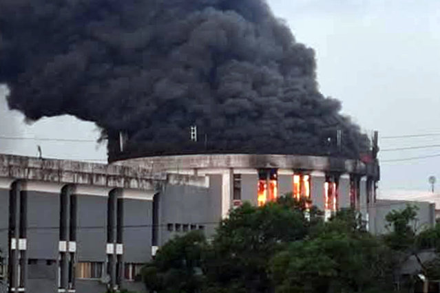 Smoke rises from the parliament building following a protest by opposition in Monrovia, Liberia, Wednesday, December 18, 2024. (Photo by Anthony Williams/AP Photo)