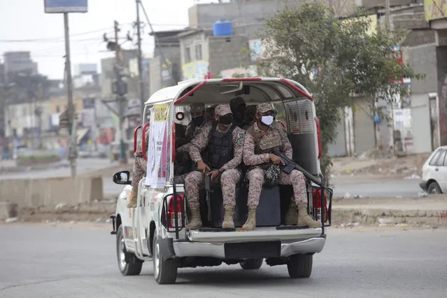 Security personnel patrol after a government announced to lockdown the city for concerns over the spread of the coronavirus in Karachi, Pakistan, Monday, March 23, 2020. The vast majority of people recover from the virus. According to the World Health Organization, most people recover in about two to six weeks, depending on the severity of the illness. (Photo by Fareed Khan/AP Photo)