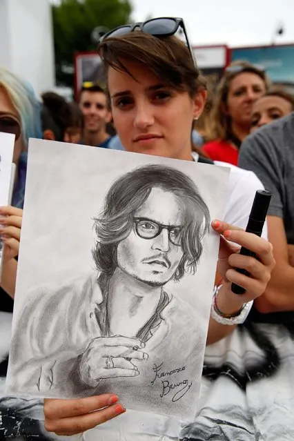 A fan await Johnny Depp at the “Black Mass” premiere during the 72nd Venice Film Festival at  on September 4, 2015 in Venice, Italy. (Photo by Tristan Fewings/Getty Images)