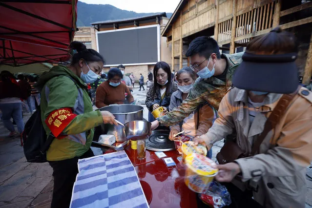 In this photo released by Xinhua News Agency, earthquake relief supplies are distributed to residents in Moxi Township of Luding County, in the aftermath of an earthquake in southwestern China's Sichuan Province, Monday September 5, 2022. (Photo by Shen Bohan/Xinhua via AP Photo)