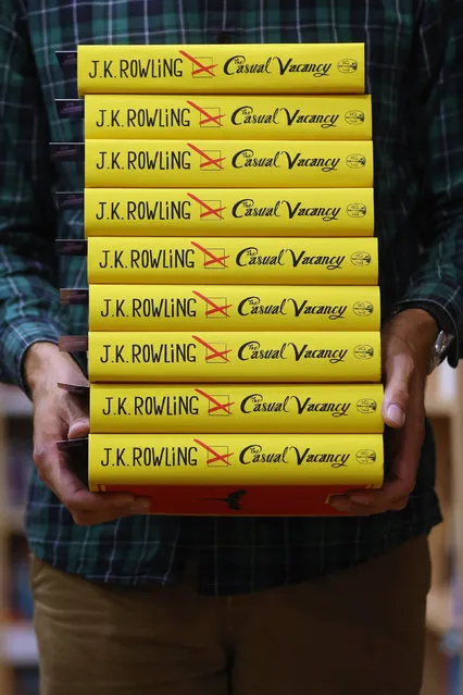 An employee at Foyles bookshop arranges copies of J. K. Rowling's latest novel 'The Casual Vacancy' which has gone on sale today starting at 8:00 am on September 27, 2012 in London, England.  'The Casual Vacancy' is J. K. Rowling's first book aimed at an adult readership and is centered on a parish council election in a small West Country town.  (Photo by Oli Scarff)