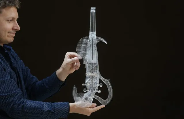French engineer and professional violinist Laurent Bernadac poses with the “3Dvarius”, a 3D printed violin made of transparent resin, during an interview with Reuters in Paris, France, September 11, 2015. (Photo by Christian Hartmann/Reuters)