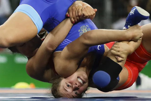 Mongolia's Orkhon Purevdorj, red, competes against Russia's Valeriia Koblova Zholobova during the women's 58-kg freestyle wrestling competition at the 2016 Summer Olympics in Rio de Janeiro, Brazil, Wednesday, August 17, 2016. (Photo by Markus Schreiber/AP Photo)