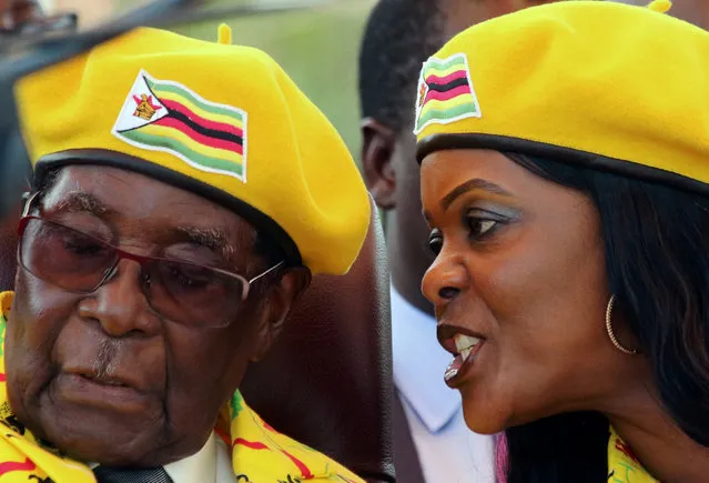 President Robert Mugabe listens to his wife Grace Mugabe at a rally of his ruling ZANU-PF party in Harare, Zimbabwe, November 8, 2017. (Photo by Philimon Bulawayo/Reuters)