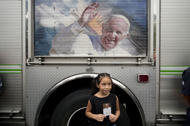 Valentina Fernandez poses for a picture holding an image of Pope Francis after a Mass to pray for his health at Constitution Square in Buenos Aires, Argentina, Monday, February 24, 2025. (Photo by Natacha Pisarenko/AP Photo)