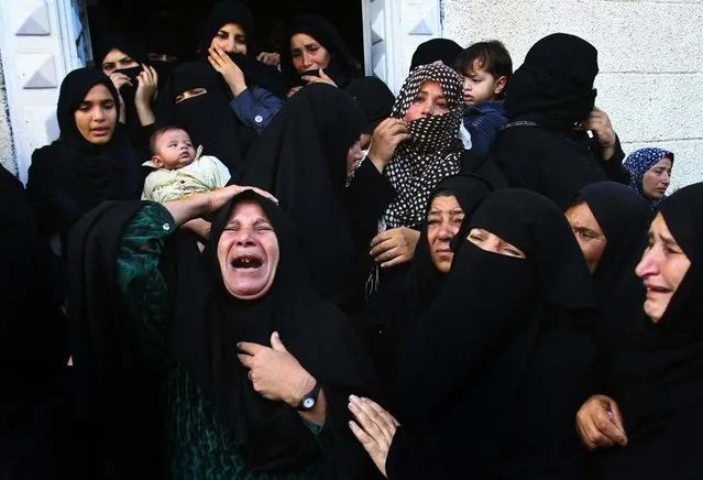 Women mourn during the funeral of Hisham Al Galban, a Hamas militant killed in an Israeli attack in the southern Gaza Strip. (Photo by Eyad Baba/Associated Press)