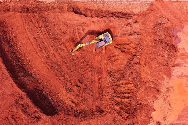 Imported iron ore is sorted into piles at the port in Qingdao, in China's eastern Shandong province on March 6, 2025. (Photo by AFP Photo/China Stringer Network)