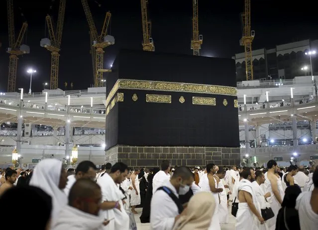 Muslim pilgrims pray around the holy Kaaba at the Grand Mosque on the first day of Eid al-Adha during the annual haj pilgrimage in Mecca September 24, 2015. (Photo by Ahmad Masood/Reuters)