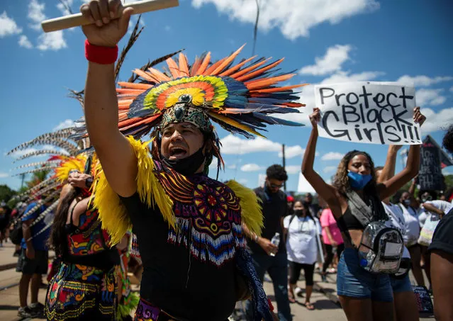 A member of the Kalpulli Yaocenoxyli Aztec community chants during a demonstration in St. Paul, Minnesota, U.S. July 12, 2020. Mothers, spouses and relatives of loved ones lost to police violence join supporters protesting racial inequality in the National Mothers March Against Police Violence in St. Paul, Minnesota. (Photo by Brandon Bell/Reuters)