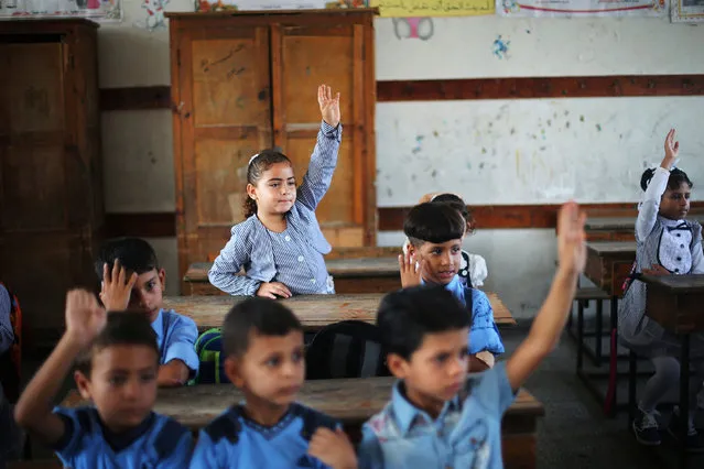 Palestinian schoolchildren attend a lesson in a classroom on the first day of a new school year, at a United Nations-run school in Khan Young in the southern Gaza Strip August 28, 2016. (Photo by Ibraheem Abu Mustafa/Reuters)