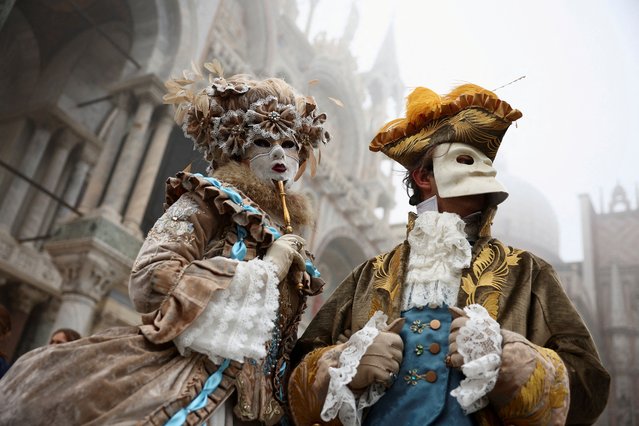 Masked revellers take part in the Venice carnival in St. Mark's Square in Venice, Italy on January 27, 2024. (Photo by Guglielmo Mangiapane/Reuters)