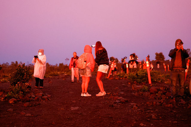 People watch the lava eruption from Halema'uma'u crater within the summit caldera Kaluapele, at the Kilauea volcano in Hawaii, U.S. March 26, 2025. (Photo by Marco Garcia/Reuters)