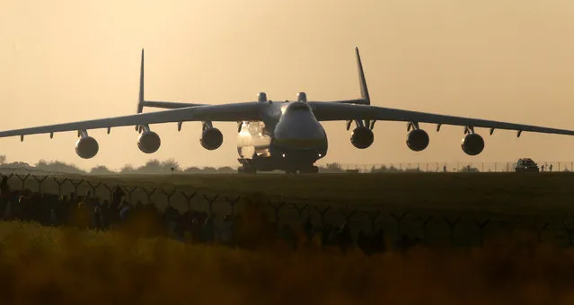 Plane spotters watch Antonov An-225 Mriya, a cargo plane which is the world's biggest aircraft, driving along the Vaclav Havel Airport for its first commercial flight from Prague to Perth, in Prague, Czech Republic, May 12, 2016. (Photo by David W. Cerny/Reuters)