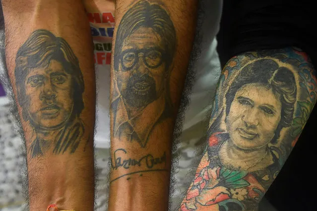 Fans show their tattoo depicting Bollywood actor Amitabh Bachchan as they participate in a special prayer organised for his speedy recovery after he tested positive for COVID-19 coronavirus, at the Amitha Bachchan temple, in Kolkata on August 2, 2020. (Photo by Dibyangshu Sarkar/AFP Photo)