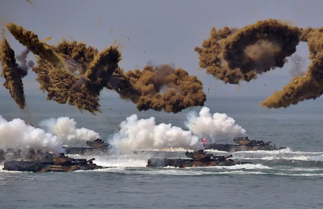 South Korean amphibious vehicles fire smoke shells during a re-enactment of the Incheon landing to mark the 66th anniversary of the start of Operation Chromite, the battle that turned the tide in the Korean War, in the western port city of Incheon on September 9, 2016. South Korea marked the 66th anniversary of the daring Incheon Landing which was led by US General Douglas MacArthur and led two weeks later to the recapture of Seoul from North Korean invaders during the Korean War. North Korea has conducted a fifth nuclear test, its most powerful to date, South Korea's President Park Geun-Hye said on September 9, condemning the move as an act of “self-destruction” that would deepen its isolation. (Photo by Jung Yeon-Je/AFP Photo)