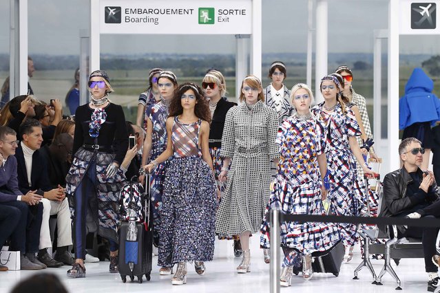 Models present creations by German designer Karl Lagerfeld as part of his Spring/Summer 2016 women's ready-to-wear collection show for fashion house Chanel at the Grand Palais which is transformed into a Chanel airport during Fashion Week in Paris, France, October 6, 2015. (Photo by Benoit Tessier/Reuters)