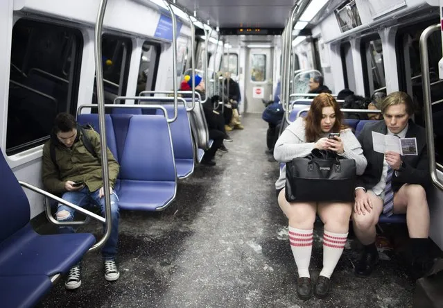Participants in the No Pants Subway Ride DC, ride on the metro on January 7, 2018 in Washington, DC. The No Pants Subway Ride is an annual event which was started in 2002 by Improv Everywhere in New York. (Photo by Andrew Caballero-Reynolds/AFP Photo)