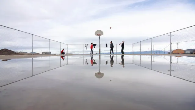 “The Arctic League”. The brand new basketball court in Pond Inlet, Nunavut sees action just after a rain. The playing season is short with only three months of the year in the pluses. But, with 24-hour daylight, games go long and late. Photo location: Pond Inlet, Nunavut, Canada. (Photo and caption by Chris Paetkau/National Geographic Photo Contest)