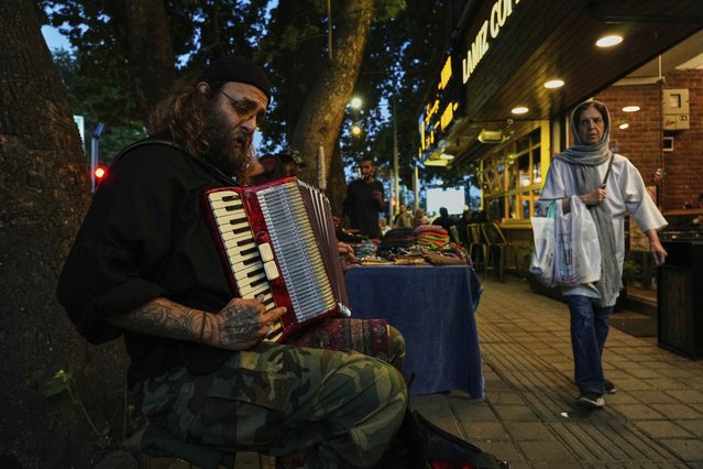 A street musician plays music on a sidewalk in northern Tehran, Iran, Wednesday, April 30, 2025. (Photo by Vahid Salemi/AP Photo)