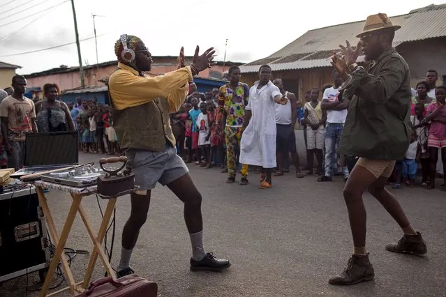 DJ Evans Mireku Kissi (L) plays experimental music during a street performance in Jamestown, Accra, Ghana, June 12, 2015. (Photo by Francis Kokoroko/Reuters)