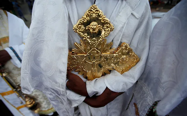 Ethiopian Orthodox Priest holds a cross during the Meskel Festival to commemorate the discovery of the true cross on which Jesus Christ was crucified on, at the Meskel Square in Ethiopia's capital Addis Ababa, September 26, 2016. (Photo by Tiksa Negeri/Reuters)