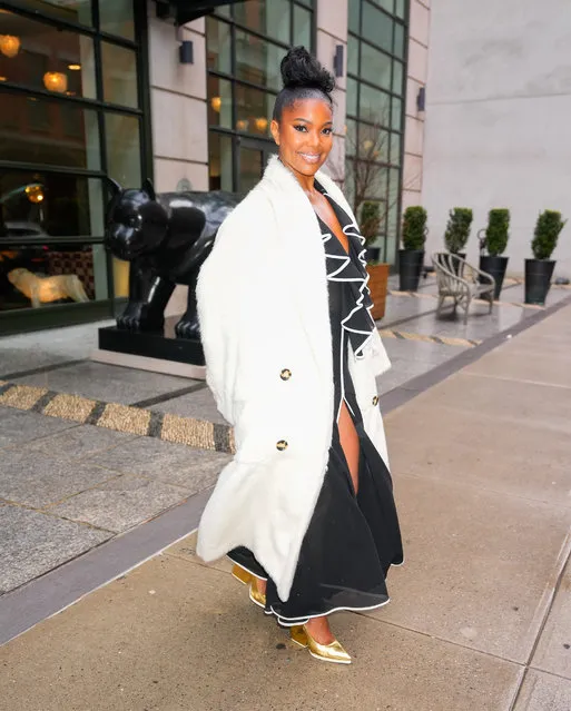 Gabrielle Union is pictured as she departs her hotel in New York City on January 25, 2023. The American actress looked stylish in a white jacket, semi sheer black dress, and gold heels. (Photo by The Image Direct)