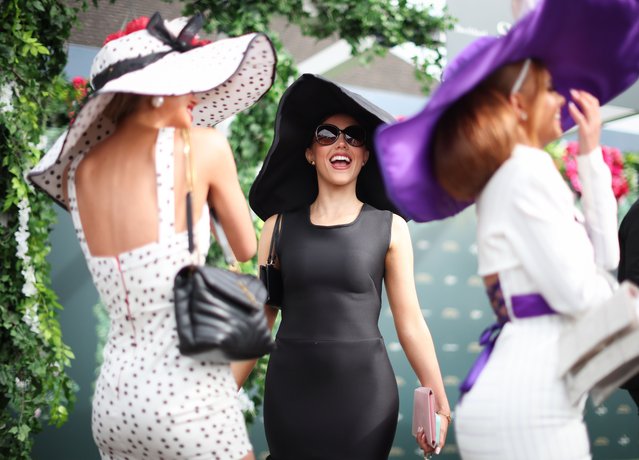 A group of friends react during “Ladies Day” at the Randox Grand National Festival held at the Aintree Racecourse near Liverpool, Britain, 12 April 2024. The Grand National Festival is held over three days, culminating in the world famous 6.9 kilometer handicapped steeplechase, running for the 176th time in 2024. (Photo by Adam Vaughan/EPA/EFE)
