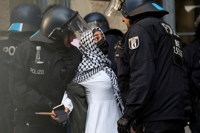 Police officers remove a pro-Palestinian demonstrator, as demonstrators occupy a building at the Humboldt University, amid the ongoing conflict between Israel and Palestinian Islamist group Hamas, in Berlin, Germany, on May 23, 2024. (Photo by Lisi Niesner/Reuters)
