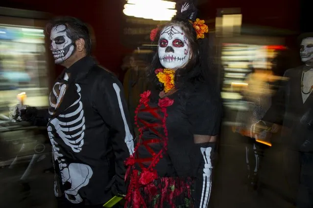 Participants march during a candlelight procession at the end of a three-day "Day of The Dead" (Dia de los Muertos) celebration that saw hundreds walk to El Campo Santo cemetery in Old Town San Diego, California November 2, 2015. (Photo by Mike Blake/Reuters)