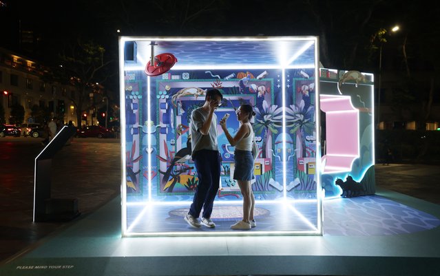 People look at installation Two Sides of Our Island by LABSIXFIVE studio during the opening of the Singapore Night Festival (SNF) 2025 in Singapore, 22 August 2025. The 16th edition of SNF, themed Island Nights, opens on 22 August with over 80 immersive and innovative experiences. (Photo by How Hwee Young/EPA)